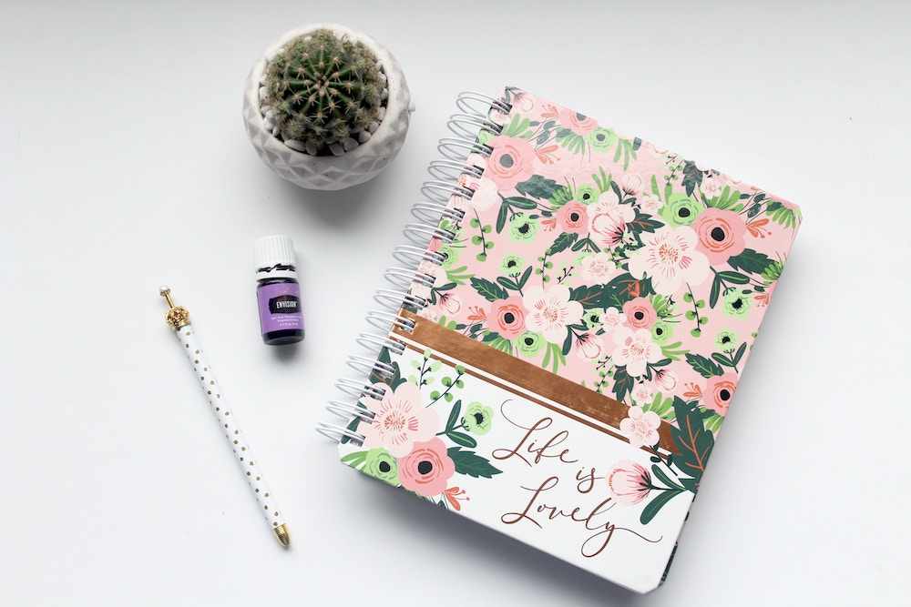 Essential oil bottle, journal and pencil