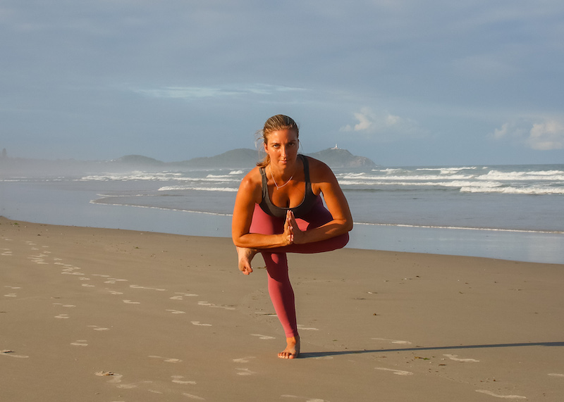 Yoga teacher in standing pigeon pose